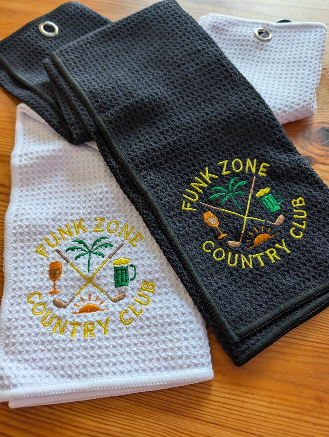 Black and white embroidered Funk Zone Country Club golf towels